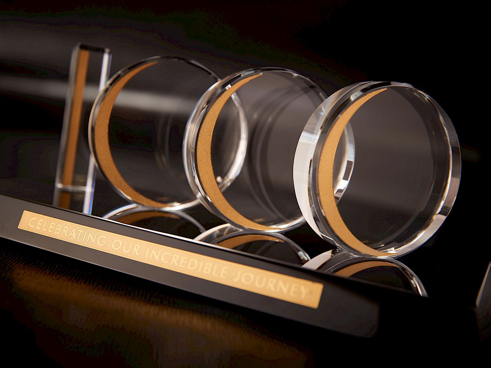 Commemorative crystal and gold veneer sculpture on black onyx inscribed base